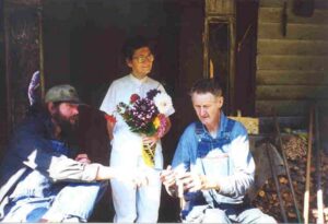 Youngest son, Ted and Ray closely examining one of their wood carvings while Rosa seems to be dreaming of her flower gardens. (Photo by: Connie Regan-Blake)