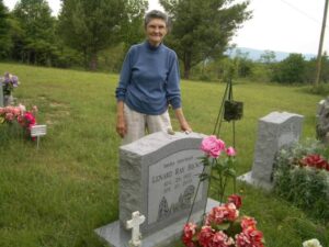 Rosa visiting Ray's gravesite with flowers. Ray was buried next to his Mom, Rena. (Photo by: Connie Regan-Blake)