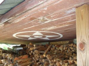 "Cut your wood and it warms you twicet." But when Ted had developed health challenges, a fund was started to raise money to build an addition to the home with kerosene heat and indoor plumbing. Thanks to all the contributors! That's a hex sign on the ceiling of the front porch. (Photo by: Connie Regan-Blake)