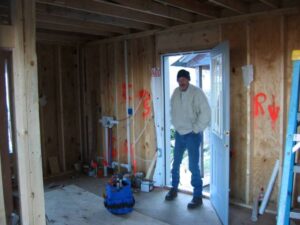 Oldest son Lenard surveying the progress. (Photo by: Connie Regan-Blake)