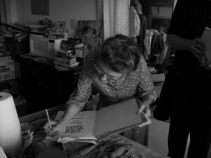 Rosa signing copies of Ray's book, "The Jack Tales: Stories by Ray Hicks." (Photo by: Hettie Barnes)