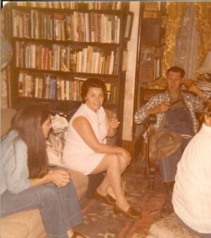 Ray telling at a gathering at Carolyn Moore's home after the very first National Storytelling festival in 1973. Ray's cousin smiling at the camera and storyteller Connie Regan-Blake listening intently. (Photo by: Barbara Freeman)